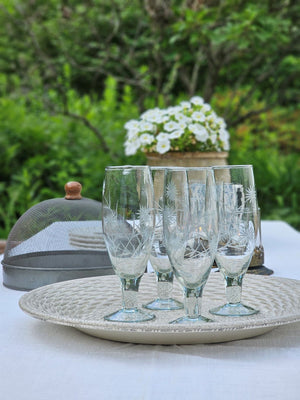 Inspired by antique shop finds, the Vintage Style Etched Flute Glasses, Set of Four brings timeless elegance to any occasion. The etched flower design lends a sophisticated vintage aesthetic that adds character and charm to any table setting. Ideal for farmhouse kitchens, cottage-style entertaining, or as a meaningful gift for those who appreciate quality glassware