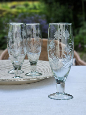 Inspired by antique shop finds, the Vintage Style Etched Flute Glasses, Set of Four brings timeless elegance to any occasion. The etched flower design lends a sophisticated vintage aesthetic that adds character and charm to any table setting. Ideal for farmhouse kitchens, cottage-style entertaining, or as a meaningful gift for those who appreciate quality glassware