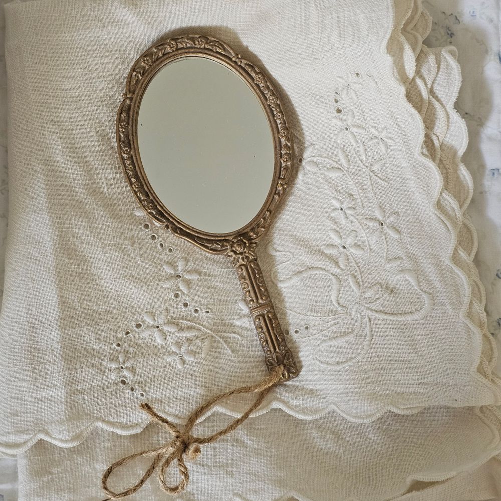 Inspired by the timeless elegance of French flea market treasures, the Vintage Style Gold Hand Mirror brings authentic charm to any vanity or boudoir. Crafted with meticulous attention to detail, this exquisite piece features an aged brass-finish handle adorned with intricate carved botanical motifs that evoke the craftsmanship of bygone eras. The high-definition mirror surface delivers crystal-clear reflection, while the antique aesthetic creates a sophisticated focal point on dressing tables.