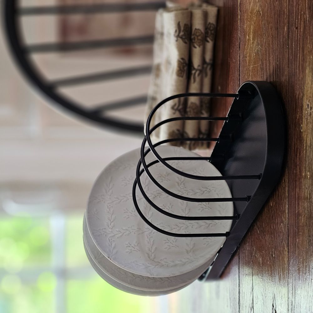 Our Vintage Style Wire Plate Rack offers a unique way to show off your collection of vintage plates and entertain with old-fashioned farmhouse flair. Our reproduction black metal and wire dish holder is perfect for creating a rustic style buffet or keep it on your dining room sideboard for everyday display of your favorite flea market finds. 