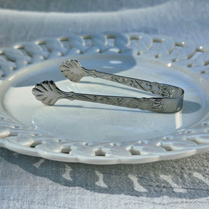 Add a touch of elegance to your entertaining with this Vintage Style Mini Serving Tong. Features a sweet shell design and detailing along the sides, this stainless steel tong is perfect for small items, fruits, such as sugar cubes, olives, ice cubes and more. .66"W x 3.54"L