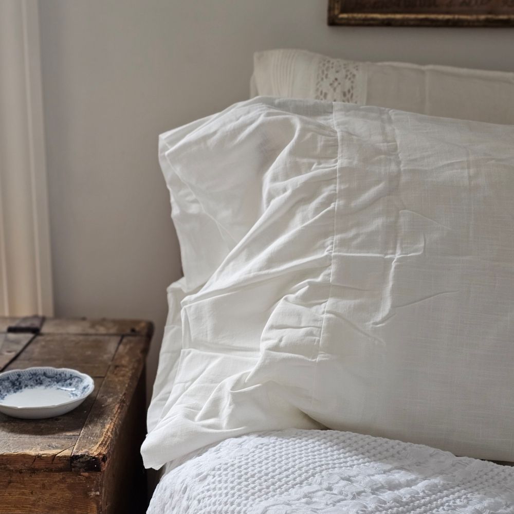 Our Vintage White Oversized Ruffled Edge Pillow Sham Set brings shabby chic and farmhouse style together to create dreamy cottage bedroom charm. This set of two antique white shams features an oversized 8 inch ruffled edge. Crafted with love from 100% cotton, they're as comforting and familiar as a handwritten letter. The gentle slub weave adds a touch of nostalgia, while the delicate ruffling dangles at the side with cloud-like softness. 