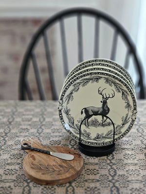 This stoneware Vintage Style Deer Plate features an elegant deer motif framed by delicate branch and acorn patterns, inspired by timeless old-world decor. Antique white with black details, it has a coordinating border design adds a refined touch, making it ideal for both everyday meals and special seasonal gatherings. Crafted for convenience, the plate is microwave, oven, dishwasher, and food safe, blending rustic charm with practical functionality. Includes one plate. 8" diam