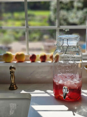 Add an old-timey touch to any occasion with our Vintage Style Glass Flip-Top Bail Wire Jar Drink Dispenser. Perfect for creating lemon infused sweet teas and lemonade, this flip-top jar is wide enough to easily add herbs and ice. The old-fashioned bail wire clamp and rubber ring keep things tightly sealed. 3.6L: 8.1" with spout x 5.8" Diam x 12.2"H