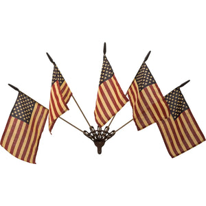 Celebrate patriotic style with our Wall Mount Flag Holder with Flags. This cast iron wall bracket comes with five vintage style American flags and will brighten any room in your farmhouse all year long. Hang it by the front door or porch or let those flags wave proudly in any room. Each flag has an aged-tea-stained patina to add vintage charm. Bracket is 4.75" without flags and 28" wide with flags