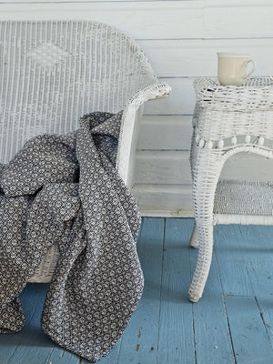 Add antique cottage charm with this Welsh Inspired Throw Blanket. Influenced by vintage Welsh tapestry patterns, this Welsh Inspired Throw Blanket adds instant warmth and character to any room. The throw features classic navy with a white diamond and floral blossom pattern. It is made from premium cotton and is machine washable for simple upkeep.