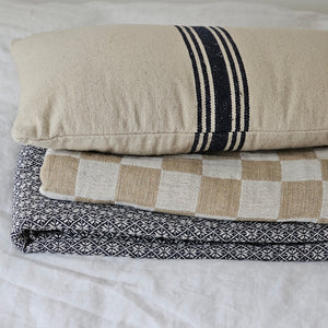 Whether it's on a bed or draped on a chair, you won't be able to resist this throw's amazing texture. The Wheat and Oatmeal Checkered Throw Blanket offers relaxed farmhouse elegance with its rustic gauze-like texture and earthy colors.  The check pattern gives it instant country farmhouse style. It comes with a carry strap, so you can easily take it along to picnics and tailgating adventures. This throw has an environmentally-friendly twist, too!