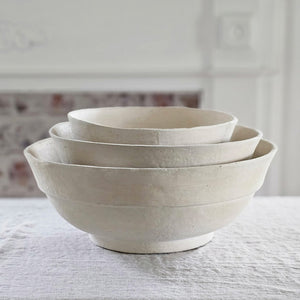 This White Farmhouse Paper Mache Bowl Set has a primitive, organic look, making them an easy fit for both modern and vintage farmhouses. Each large white bowl has a hand-crafted, timeless feel and a chalky white finish. The set includes three large sturdy bowls, perfect for adding a minimal farmhouse touch to any tabletop. For decorative use only. Set of three. 