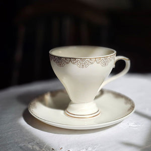 White Porcelain Tea Cup and Saucer with Gold Lace Design