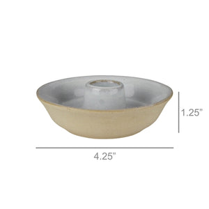 This simple White Glazed Ceramic Taper Candle Bowl, with its quiet elegance and clean design, adds instant ambience to any room. This ceramic taper holder is equal parts modern simplicity and organic imperfection. Features a white glaze finish with a natural, un-glazed bisque exterior.  Fits regular size tapers (candle not included). 4.25" diam x 1.25"H