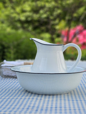 Bring the easy charm of country cottage living to your farmhouse with our White Enamel Pitcher with black rim. The simple allure of enamelware fits right in with any decor, but every farmhouse needs at least one piece. Inspired by flea market finds, our vintage style white enamel pitcher has black trim and makes the perfect vase for your favorite bouquet. Not food safe. Pitcher measures 7.5" H x 8" W (with handle) x 4.5" Diam