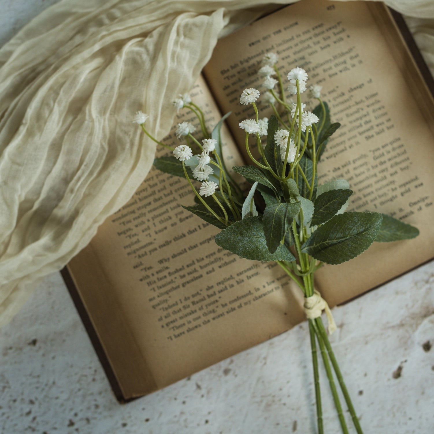 Let the garden spirit fill your farmhouse with this sweet White Mini Flower Bundle. This faux floral pick is lush and packed with delicate blossoms, making it an easy choice to fill any basket or vase. Each bundle features three stems with small creamy white blossoms teeming with a natural verve.
