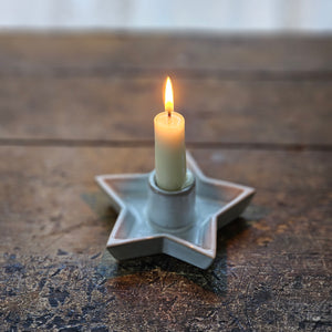 This simple Star Candle Holder with White Glaze, lends a quiet elegance and clean design to add instant ambience to any room. This ceramic taper holder is equal parts modern simplicity and organic imperfection. Features a white glaze finish. Fits regular size tapers (candle not included)