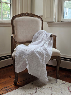 The Crisp White Waffle Weave Throw Blanket lends a fresh, clean, textured look to any room. Perfect for all seasons, this 100% cotton, lightweight blanket is ultra soft and lends a chic minimal farmhouse feel with its crisp white weave. Machine wash, tumble dry low. Becomes softer with every wash. Dries quickly, cutting down on laundry time. Made with 100% cotton. 