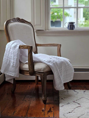 The Crisp White Waffle Weave Throw Blanket lends a fresh, clean, textured look to any room. Perfect for all seasons, this 100% cotton, lightweight blanket is ultra soft and lends a chic minimal farmhouse feel with its crisp white weave. Machine wash, tumble dry low. Becomes softer with every wash. Dries quickly, cutting down on laundry time. Made with 100% cotton. 