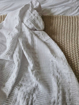 The Crisp White Waffle Weave Throw Blanket lends a fresh, clean, textured look to any room. Perfect for all seasons, this 100% cotton, lightweight blanket is ultra soft and lends a chic minimal farmhouse feel with its crisp white weave. Machine wash, tumble dry low. Becomes softer with every wash. Dries quickly, cutting down on laundry time. Made with 100% cotton. 