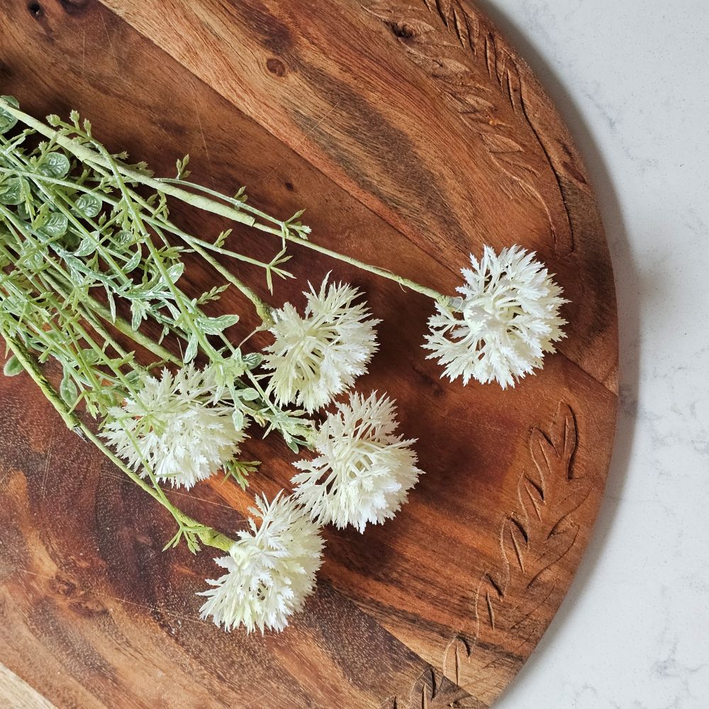 Add English cottage style with our White Allium Blossom Spray. This faux flower spray features three creamy white allium blossoms with green wildflower style leaves. The stem is long, slender, and flexible and is easily shaped for a desired look. It can be displayed alone for a simple country look or arranged into a bouquet. It easily fits into baskets, buckets, and milk cans and more. Includes one spray. 19”H