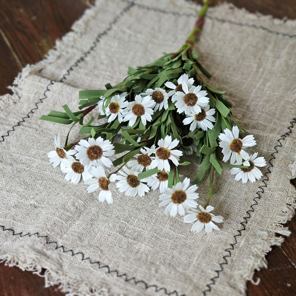 Add cottage charm to any vase, basket or vintage pitcher with our White Mini Daisy Bush. This classic country Daisy Bush features white silk flowers and soft foam leaves on a flexible green floral stem. Measures 18" Flower Bush only: not sold with containers.