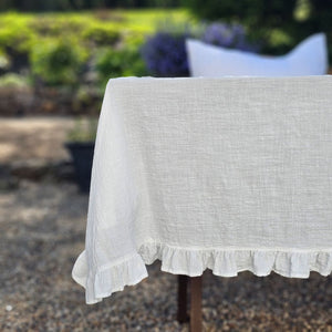 Add dreamy country charm to any occasion with our White Ruffle Prairie Tablecloth. Features a sweet ruffle trim and crisp white cotton. Inspired by vintage home linens, this cotton tablecloth gets prettier with every wash. Create instant cottage style or a dreamy farmhouse tables design for your next event
