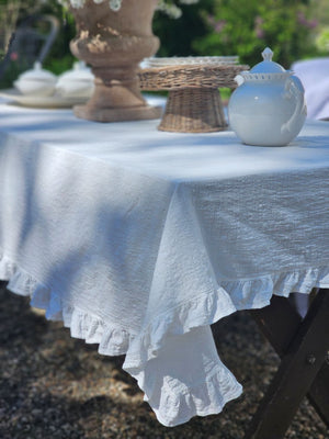 Add dreamy country charm to any occasion with our White Ruffle Prairie Tablecloth. Features a sweet ruffle trim and crisp white cotton. Inspired by vintage home linens, this cotton tablecloth gets prettier with every wash. Create instant cottage style or a dreamy farmhouse tables design for your next event