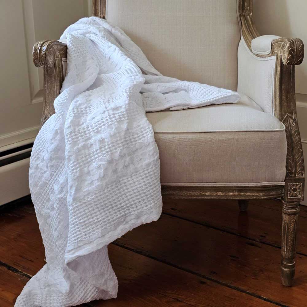 The Crisp White Waffle Weave Throw Blanket lends a fresh, clean, textured look to any room. Perfect for all seasons, this 100% cotton, lightweight blanket is ultra soft and lends a chic minimal farmhouse feel with its crisp white weave. Machine wash, tumble dry low. Becomes softer with every wash. Dries quickly, cutting down on laundry time.