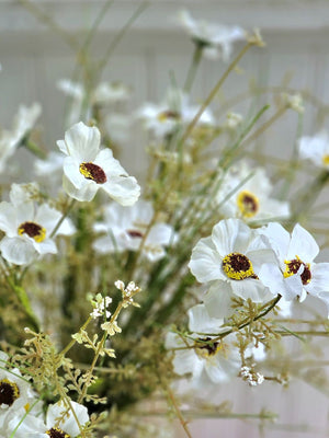 Farmhouse cottage style is made easy with our White Wildflower Spray Pick. This faux flower spray features creamy white fabric petals with brown and yellow pistil centers for a realistic touch. Fresh green leaves on a plastic green stem complete this floral. The stem is long, slender, and flexible and is easily shaped for a desired look.