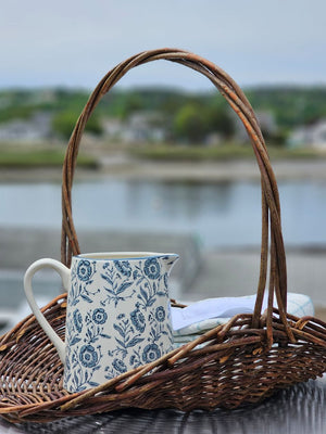 This charming White and Blue Floral Pitcher brings timeless farmhouse elegance to your kitchen or dining table. Crafted with a creamy white base adorned with delicate blue floral motifs, its classic pitcher silhouette evokes the warmth and simplicity of country cottage living. Perfect for serving beverages at gatherings, displaying fresh flowers, or adding a nostalgic touch to your home decor, this piece captures the heart of cottage style