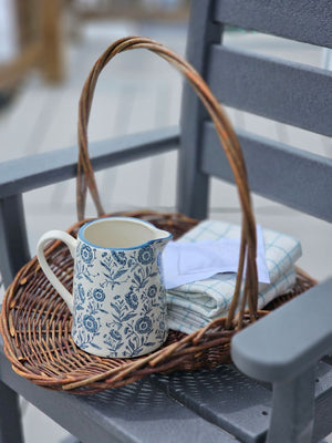 This charming White and Blue Floral Pitcher brings timeless farmhouse elegance to your kitchen or dining table. Crafted with a creamy white base adorned with delicate blue floral motifs, its classic pitcher silhouette evokes the warmth and simplicity of country cottage living. Perfect for serving beverages at gatherings, displaying fresh flowers, or adding a nostalgic touch to your home decor, this piece captures the heart of cottage style
