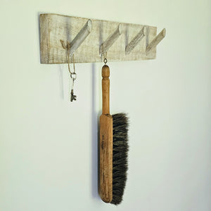 This Whitewash Wood Peg Coat Rack is perfect for those who appreciate minimalist  farmhouse style. Its simple design and whitewash finish reveals natural hints of wood, allowing it to fit any rustic, modern, or coastal farmhouse interior. It's sure to bring a sophisticated touch to your mudroom, entryway, or any other room, while providing four sturdy pegs to keep your coats, scarves, and more organized. 21"L x 4"