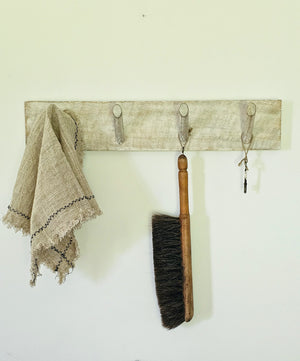 This Whitewash Wood Peg Coat Rack is perfect for those who appreciate minimalist  farmhouse style. Its simple design and whitewash finish reveals natural hints of wood, allowing it to fit any rustic, modern, or coastal farmhouse interior. It's sure to bring a sophisticated touch to your mudroom, entryway, or any other room, while providing four sturdy pegs to keep your coats, scarves, and more organized. 21"L x 4"H