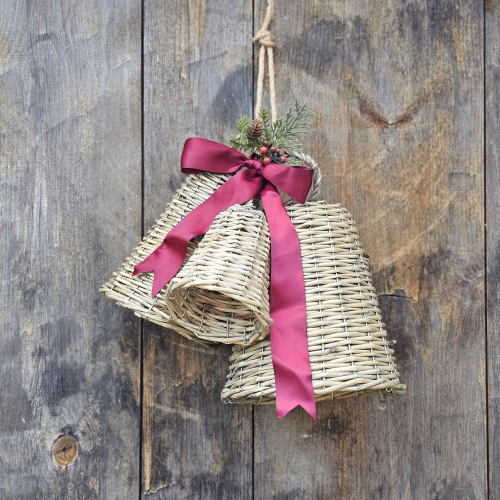 Experience the charm of the holiday season with our Wicker Bells with Rope Hangers, Set of Three. These rustic woven willow bells feature a cozy cottage feel. Embellish your set with ribbons and greenery for added festive charm. With hoops for easy hanging and sold in a set of three, these bells are the perfect addition to your holiday decor. Ribbon and Greenery not included. 