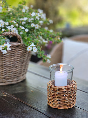This Willow Candle Basket with Glass Jar brings French Country cottage charm to your home or garden decor. The thick glass insert allows you to enjoy it as an elegant candle hurricane or use it as vase packed with your favorite flowers. You can use the pieces separately. The Glass jar is beautiful for storage or display while the willow basket makes an attractive sleeve for small garden pots. 5” diam x 6”H
