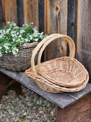 This Willow Gathering Basket Set adds a bit romance and style to the art of gardening and flower collecting. These low profile baskets are also perfect for picnics or keeping your home organized. The ageless beauty of natural fibers are woven together to make these functional, yet beautiful wicker baskets ready to be your workhorse. Create stunning farm table centerpieces by adding your favorite fruits and flowers. English cottage style with functionality at its best. Set of two.