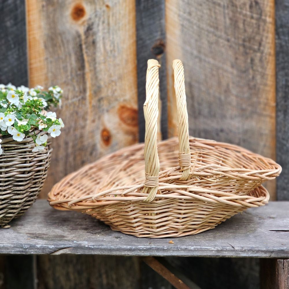 This Willow Gathering Basket Set adds a bit romance and style to the art of gardening and flower collecting. These low profile baskets are also perfect for picnics or keeping your home organized. The ageless beauty of natural fibers are woven together to make these functional, yet beautiful wicker baskets ready to be your workhorse. Create stunning farm table centerpieces by adding your favorite fruits and flowers. English cottage style with functionality at its best. Set of two.
