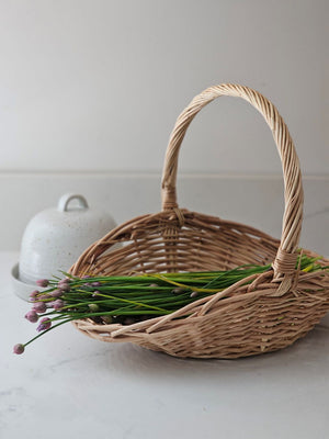 This Willow Gathering Basket Set adds a bit romance and style to the art of gardening and flower collecting. These low profile baskets are also perfect for picnics or keeping your home organized. The ageless beauty of natural fibers are woven together to make these functional, yet beautiful wicker baskets ready to be your workhorse. Create stunning farm table centerpieces by adding your favorite fruits and flowers. English cottage style with functionality at its best. Set of two.