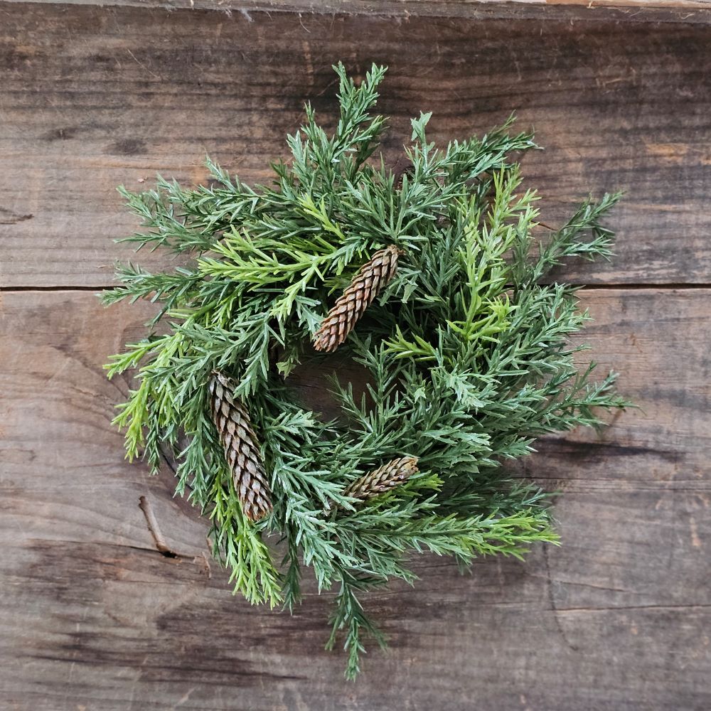 Our Winter Green Pine Candle Ring brings fresh, earthy greenery to your farmhouse decor. Perfect for adding cabin style or a rustic twist to taper candle holders and chandeliers, this faux pine candle ring will provide a charming decorative accent all year long.