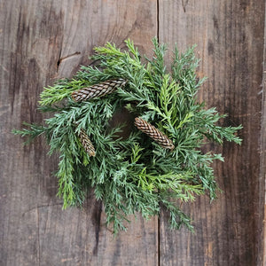 Our Winter Green Pine Candle Ring brings fresh, earthy greenery to your farmhouse decor. Perfect for adding cabin style or a rustic twist to taper candle holders and chandeliers, this faux pine candle ring will provide a charming decorative accent all year long.