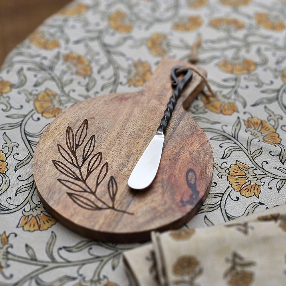 Expertly crafted with a rustic elegance, the Olive Branch Wood Cutting Board with Iron Spreader is a versatile addition to your kitchen. This small board is perfect for cutting or serving and features an etched olive branch design. The wood cutting board comes with the primitive iron spreader that features a twisted handle design for added rustic charm. 