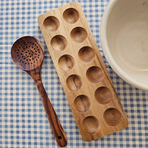 Inspired by antique egg holders, such as ones spotted in the Downton Abbey kitchen,  our farmhouse Wood Egg Tray will be right at home in your kitchen. It makes a great accent for any shelf or countertop. The rustic wood egg crate holds 12 eggs. Eggs not included.