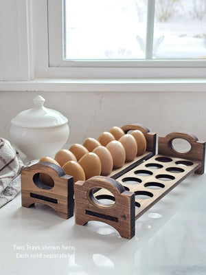 Inspired by antique egg holders, such as ones spotted in the Downton Abbey kitchen, our farmhouse Rustic Wood Stackable Egg Tray will be right at home in your kitchen. It is sold as one tray, and a purchase of two gives you that old-timey stackable look. Makes a great accent for any shelf or countertop. Each rustic wood egg crate holds 12 eggs. Eggs not included. Includes one tray. Purchase two or more for stacking. Made in the USA. 12"L x 3"W x 3.5"H