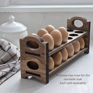 Inspired by antique egg holders, such as ones spotted in the Downton Abbey kitchen, our farmhouse Rustic Wood Stackable Egg Tray will be right at home in your kitchen. It is sold as one tray, and a purchase of two gives you that old-timey stackable look. Makes a great accent for any shelf or countertop. Each rustic wood egg crate holds 12 eggs. Eggs not included. Includes one tray. Purchase two or more for stacking. Made in the USA. 12"L x 3"W x 3.5"H