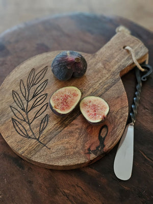 Expertly crafted with a rustic elegance, the Olive Branch Wood Cutting Board with Iron Spreader is a versatile addition to your kitchen. This small board is perfect for cutting or serving and features an etched olive branch design. The wood cutting board comes with the primitive iron spreader that features a twisted handle design for added rustic charm. 