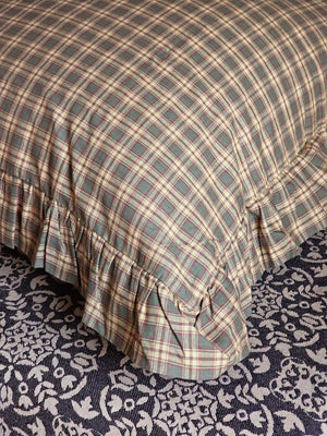  Woodland Cottage Plaid Euro Sham. This 26x26-inch accent piece showcases a refined tartan plaid in nature-inspired hues—olive green, deep reddish-brown, and warm tan—creating a sophisticated yet relaxed aesthetic. 