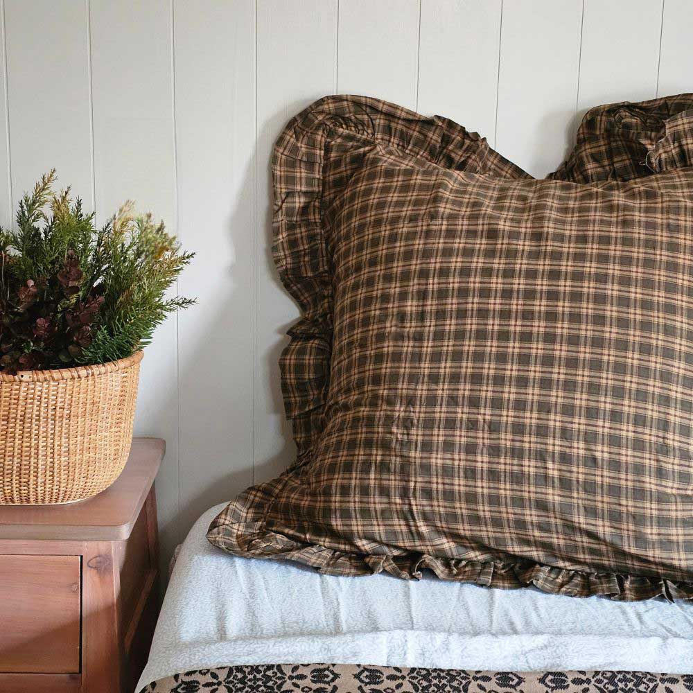  Woodland Cottage Plaid Euro Sham. This 26x26-inch accent piece showcases a refined tartan plaid in nature-inspired hues—olive green, deep reddish-brown, and warm tan—creating a sophisticated yet relaxed aesthetic. 