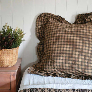 Woodland Cottage Plaid Euro Sham. This 26x26-inch accent piece showcases a refined tartan plaid in nature-inspired hues—olive green, deep reddish-brown, and warm tan—creating a sophisticated yet relaxed aesthetic. 