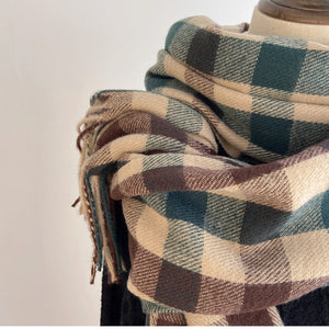 Our thoughtfully designed Woodland Plaid Scarf is an exceptionally soft and cozy knit wrap. This scarf is the perfect travel companion, offering warmth and convenience on the go. It effortlessly elevates any outfit, whether you're lounging at home or exploring while on the go. Made from a cashmere blended acrylic. Hand wash. 27.5"×78.7"