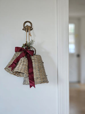 Add vintage old-world charm to any room with our Antiqued Brass Wreath Wall Hook. The aged brass finish and an ornate wreath design lends easy elegance to your home. Include two screws for hanging. With Wicker Bells