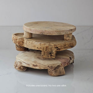 The Chapati Board is a long-standing household necessity in homes across India. These authentic, refurbished Vintage Bleached Chapati Boards take a modern turn as a home accent. No two are alike. These round wood slabs with small legs make unique farmhouse display pedestal risers. Use as a trivet or to display candles, plants and more. They're rich history leaves the wood with cracks and aged patinas. 