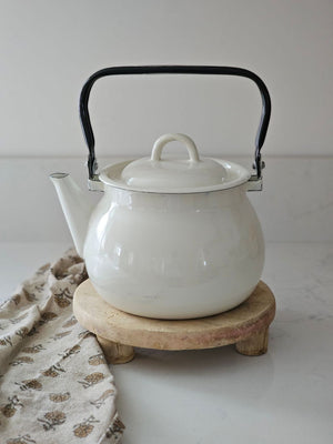 The Chapati Board is a long-standing household necessity in homes across India. These authentic, refurbished Vintage Bleached Chapati Boards take a modern turn as a home accent. No two are alike. These round wood slabs with small legs make unique farmhouse display pedestal risers. Use as a trivet or to display candles, plants and more. They're rich history leaves the wood with cracks and aged patinas. 