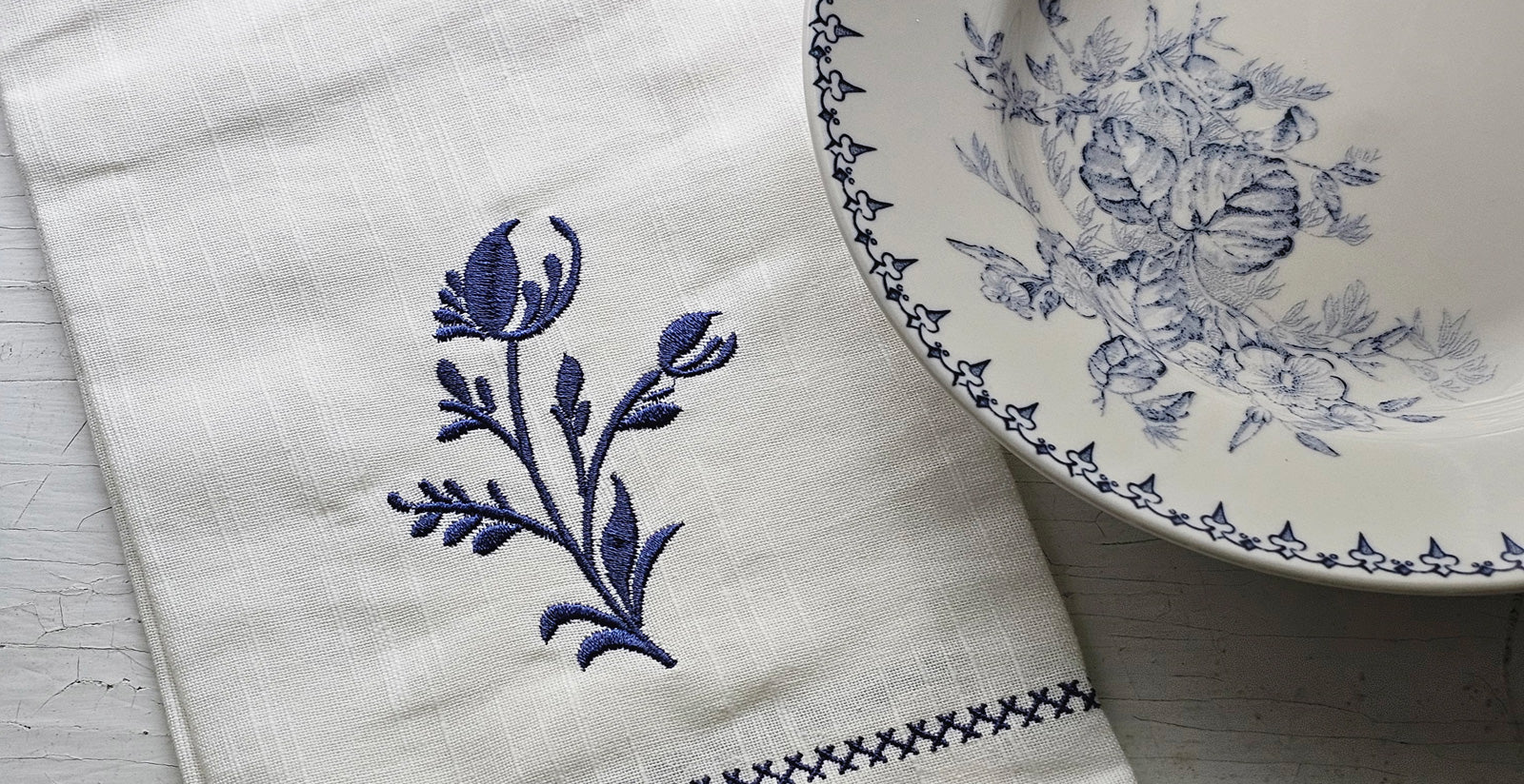 https://farmhousewares.com/cdn/shop/files/slide-embroidered-delft-blue-towel_1600x.jpg?v=1697729725